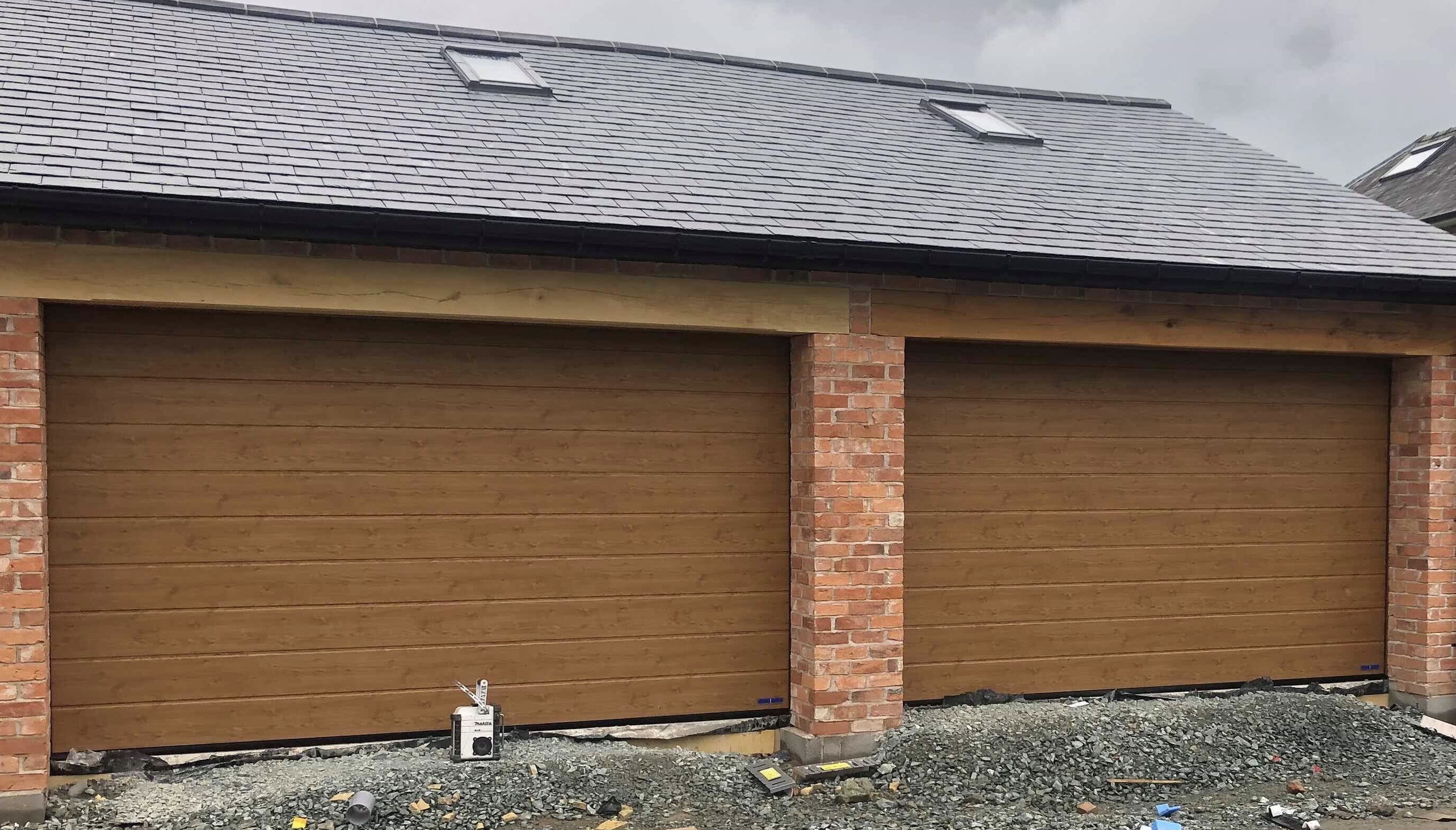 Two insulated sectional garage doors in Golden Oak finish